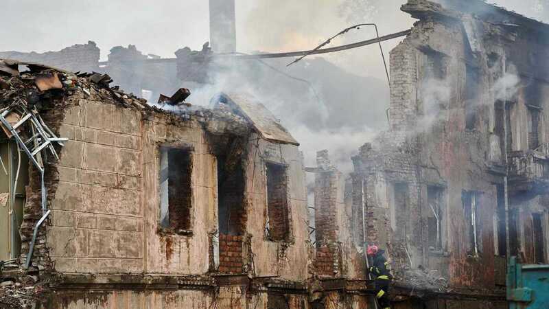 A firefighter examines the destroyed building of a medical facility, the site of a missile strike, in the city of Dnipro on May 26, 2023, amid the Russian invasion of Ukraine. (Photo by Vitalii Matokha / AFP)