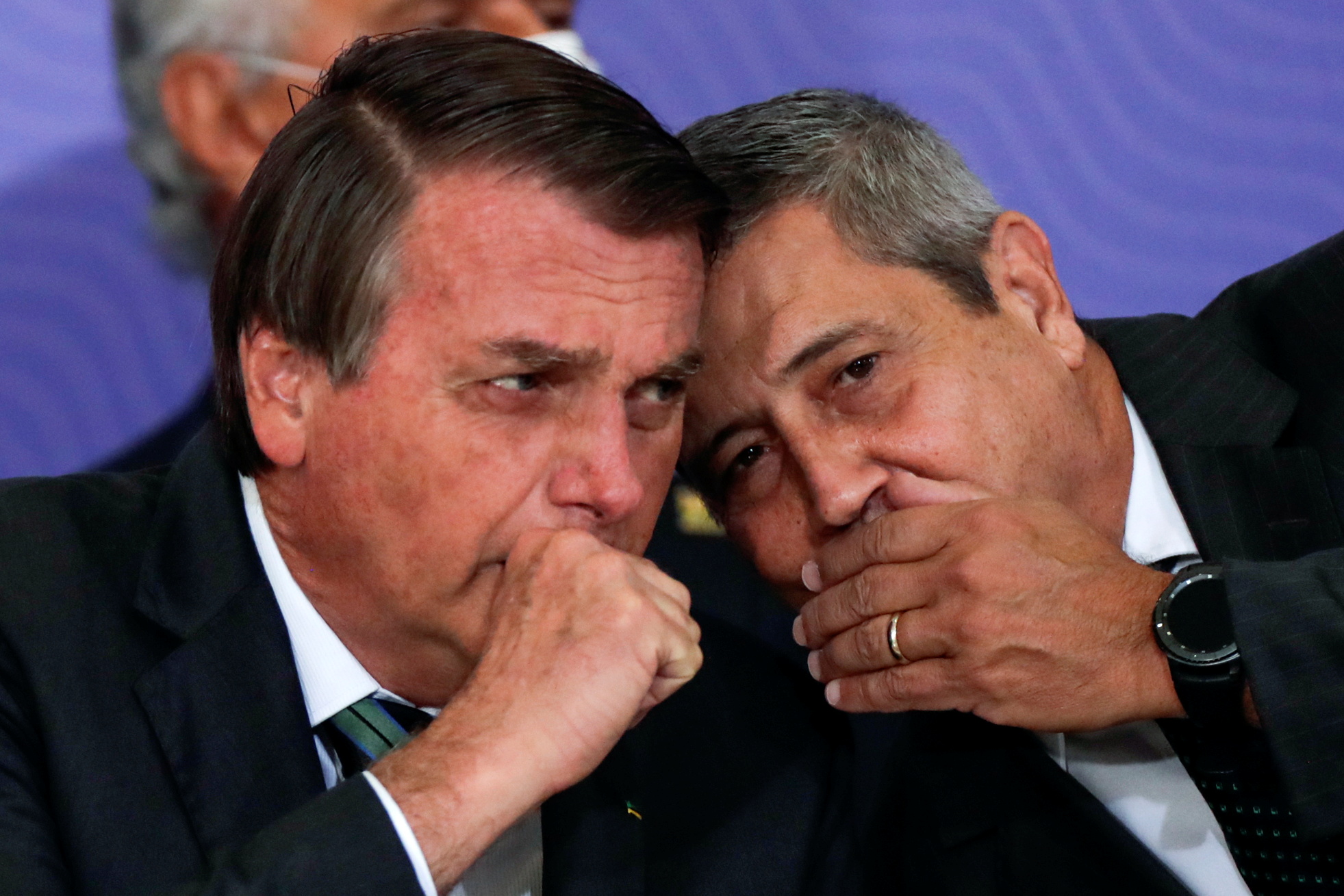 Brazil's President Jair Bolsonaro talks with his chief of staff, Army General Walter Souza Braga Netto, during a ceremony to announce a mass coronavirus disease (COVID-19) immunization program, at the Planalto Palace in Brasilia, Brazil, December 16, 2020. REUTERS/Ueslei Marcelino