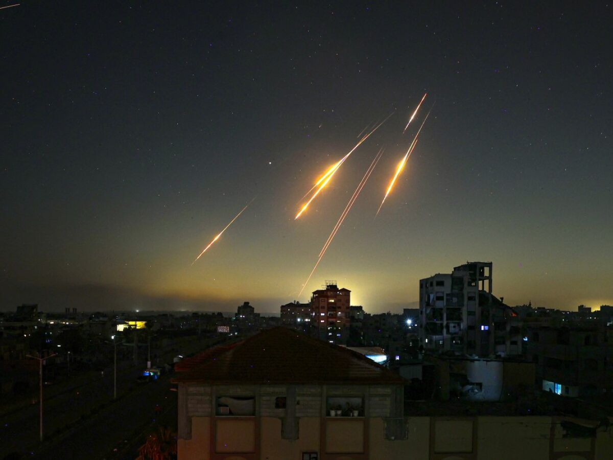 This picture taken from Nuseirat, in the central Gaza Strip, shows rocket trails in the sky late on June 13, 2025, after Iran struck Israel with barrages of missiles after a massive onslaught targeted the Islamic republic's nuclear and military facilities. (Photo by Eyad BABA / AFP)