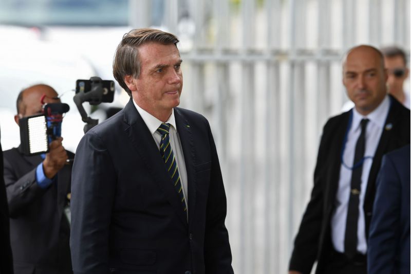 Brazilian President Jair Bolsonaro leaves Alvorada Palace in Brasilia, on April 14, 2020. Brazil, the hardest-hit Latin American country in the coronavirus pandemic, passed the mark of 1,000 deaths on Friday, the health ministry said. / AFP / EVARISTO SA